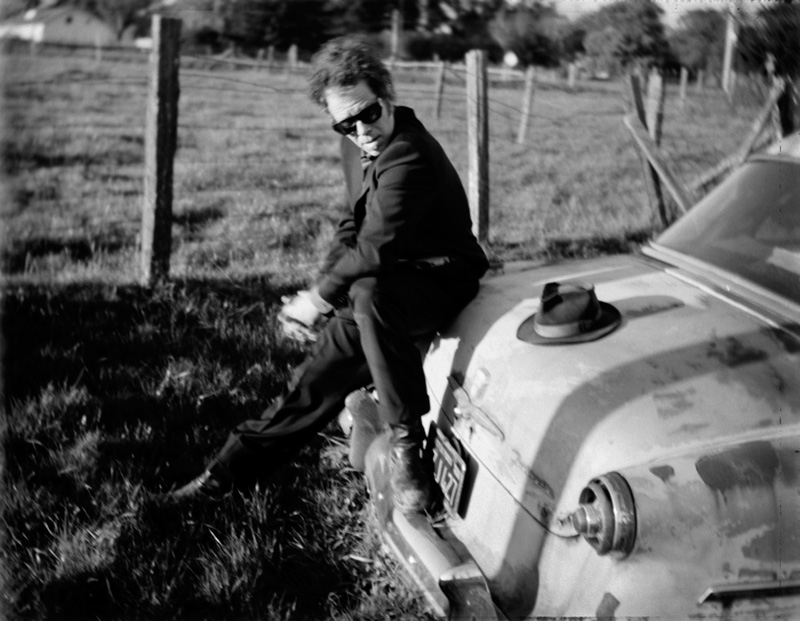 Tom Waits Sitting on Vintage Car Trunk, Sonoma County, CA, 1999