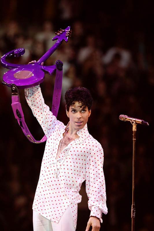 Prince Onstage in Polka Dots Holding Purple Guitar Up, MSG, 2004